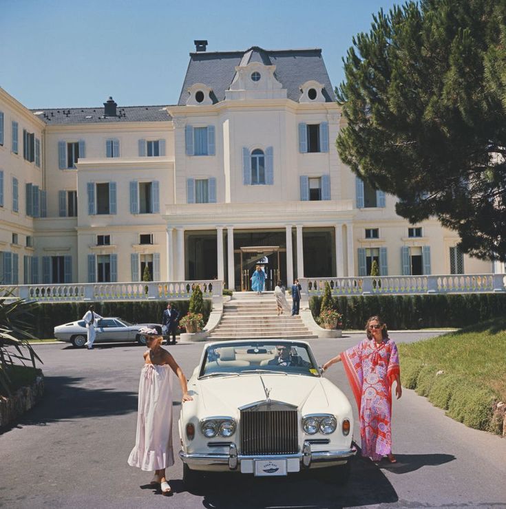 Grand white hotel with a vintage car